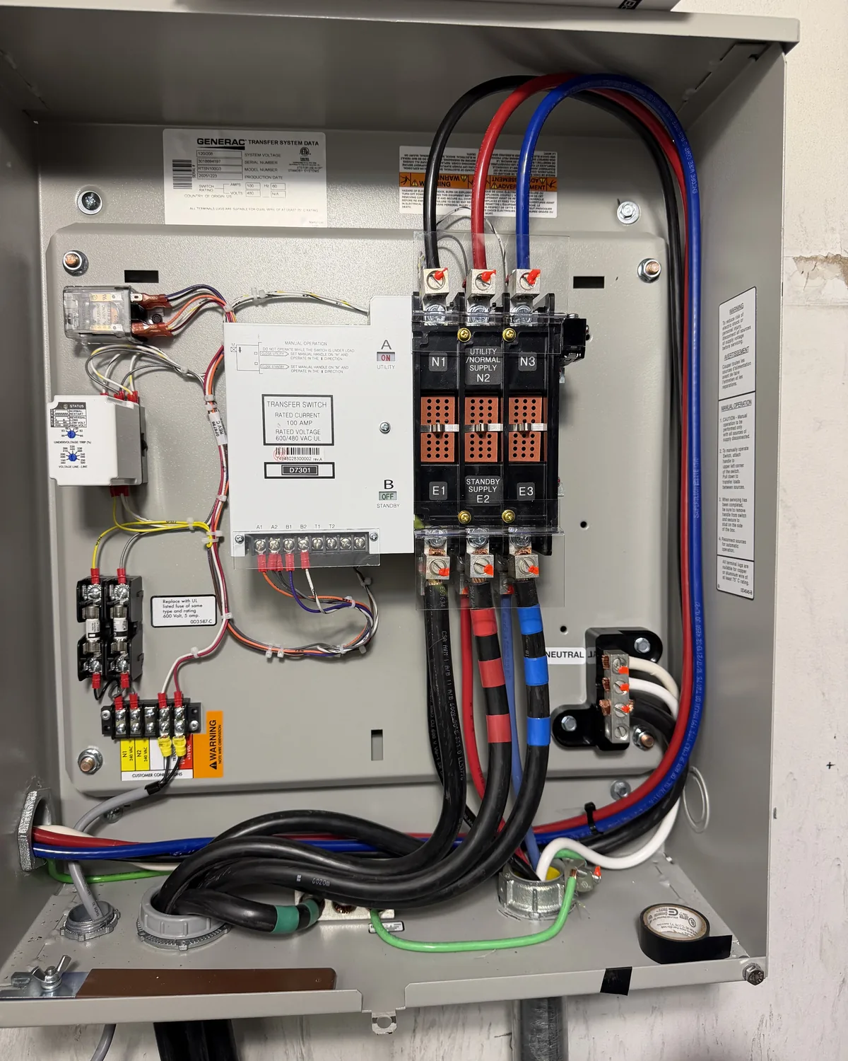 A clean commercial control enclosure with contactors, a small distribution block and neatly routed conductors